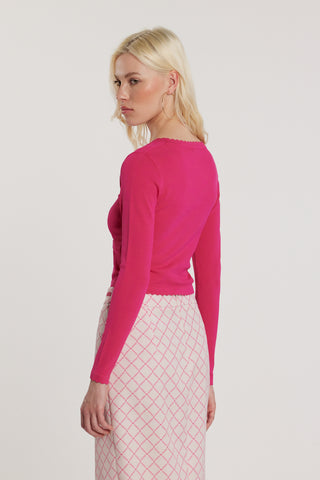 Maglia ADELE maniche lunghe scollo alla madonna con finta apertura più bottoni più applicazioni logo e fiocco